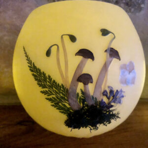 large beeswax lantern with mushrooms, flowers & ferns pressed into the wax
